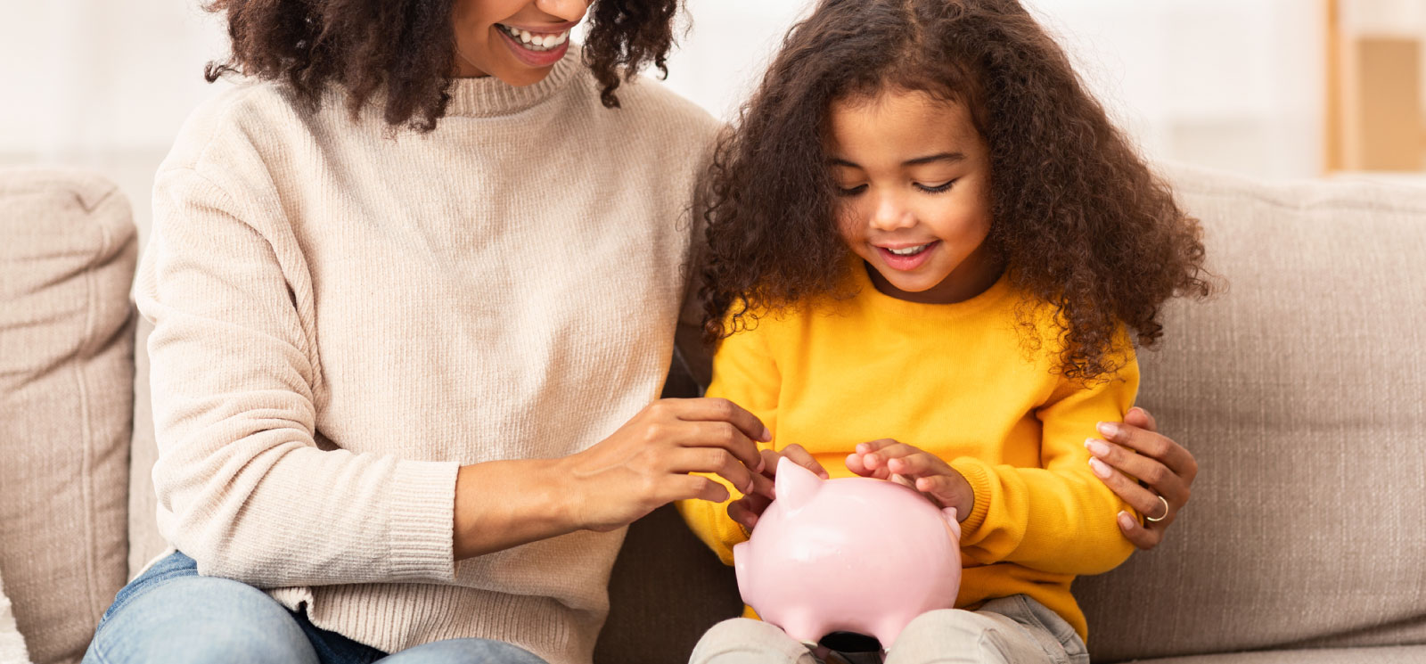 parent and child putting money in savings