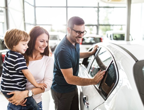 family looking at new car